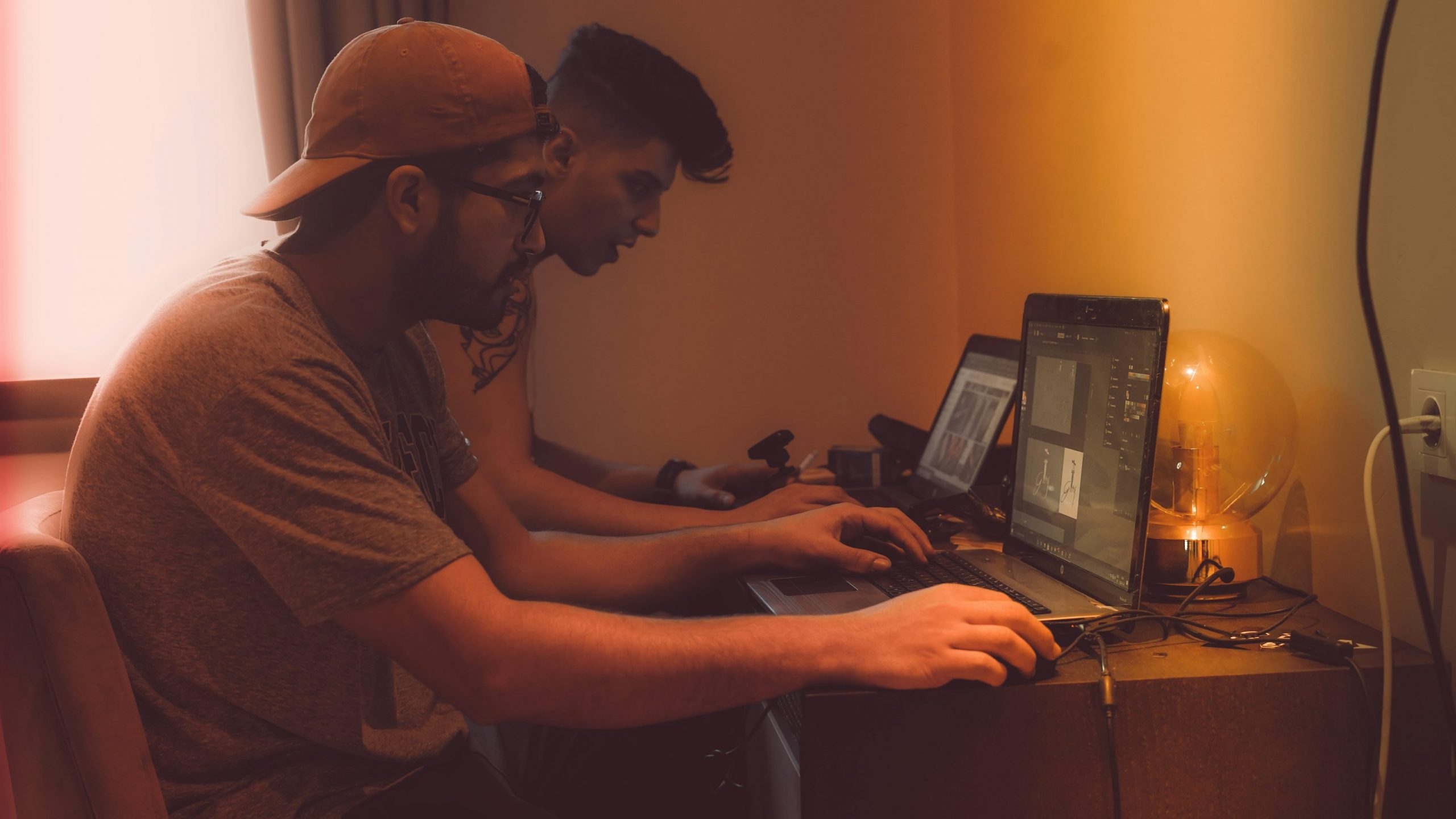 man in brown shirt using computer