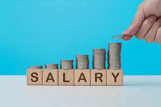 Stack of coins on word salary